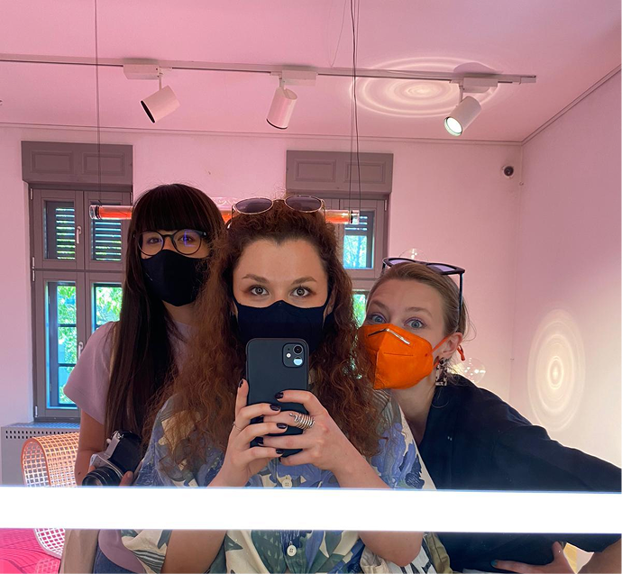 Three friends, pink light, mirror selfie