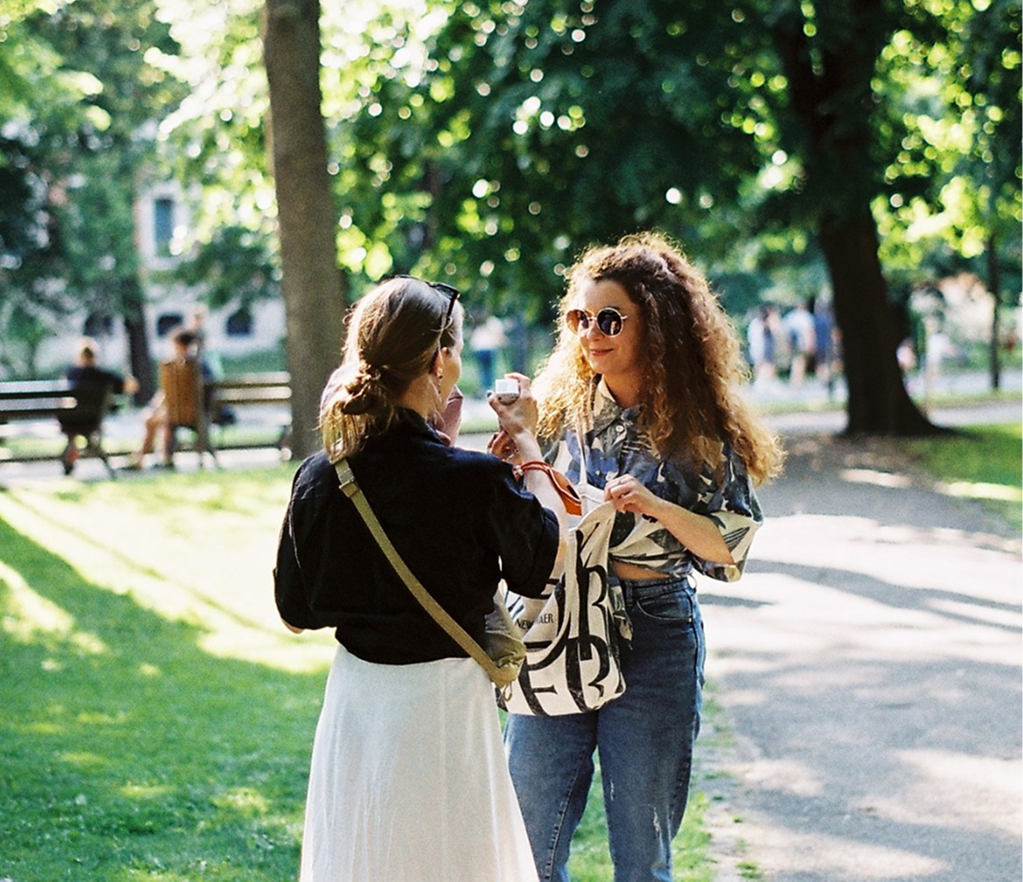 Sunlit park, two friends talking