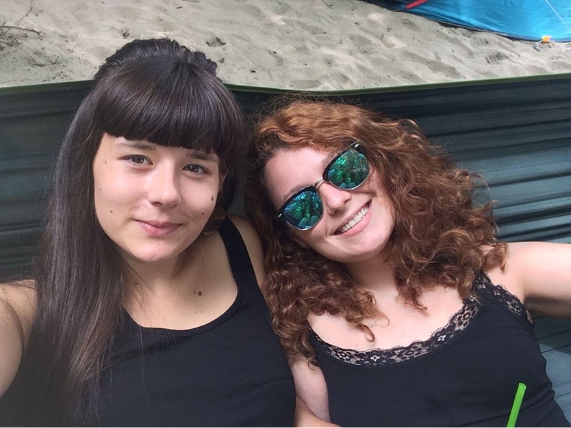 Two friends at a festival, at the beach